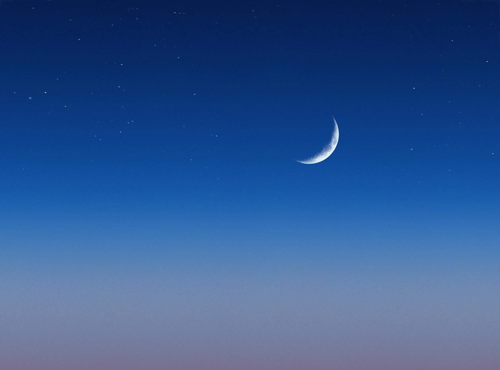 crescent moon in the blue night sky